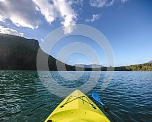 Kayak Boat Point of View on Turquoise Mountain Lake Water