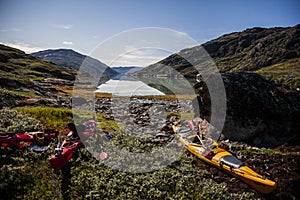 Kayak expedition between icebergs in Narsaq fiords, South West Greenland, Denmark photo