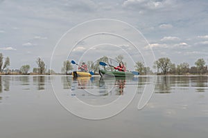 Kayak fishing at lake. Fisherwoman on inflateble boat with fishi