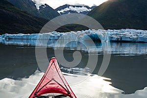 Kayak moving toward the calving face of the Spencer Glacier in A