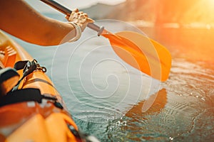 Kayak paddle sea vacation. Person paddles with orange paddle oar on kayak in sea. Leisure active lifestyle recreation