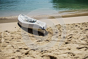 Kayak and paddle by the seashore on the beautiful white sand of Labadee, Haiti.