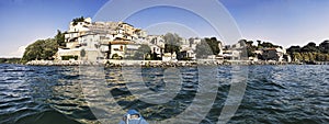 Kayak point of view of view of beautiful and picturesque village of Anguillara Sabazia located on the shores of Lake Bracciano