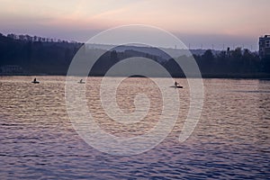 Kayak swim in the evening on the lake at sunset day