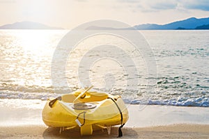 Kayak on tropical beach in sunset, vintage tone