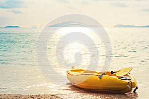 Kayak on tropical beach in sunset, vintage tone