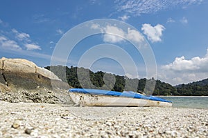 Kayak on tropical sandy beach island and bright sunny day.