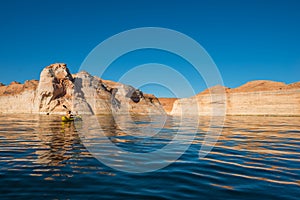 Kayaker paddling the calm waters of Lake Powell Utah photo