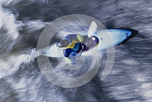 Kayaker Paddling Through Rapids