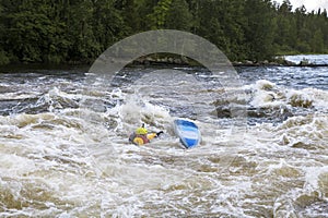 Kayaker in whitewater on a Karelian river