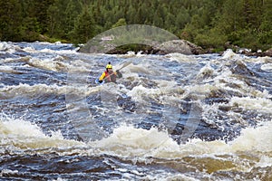 Kayaker in whitewater on a Karelian river