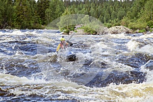 Kayaker in whitewater on a Karelian river
