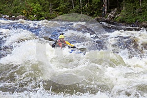 Kayaker in whitewater on a Karelian river