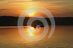 Kayakers against summer sunset