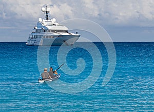 Kayakers on the kayak and a beautiful yacht in the background of clouds on the island of Kefalonia in the Ionian Sea in Greece