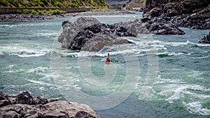 Kayakers navigating through the White Water Rapids and around Rocks