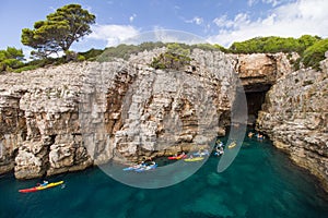 Kayakers at a sea cave at the Lokrum Island in Croatia