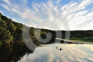 Kayakers on serene lake paddling