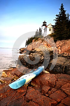 Kayaking in acadia national park in Maine next to a lighthouse