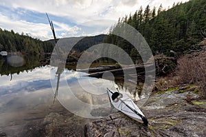 Kayaking in calm water with Canadian Mountain Landscape Background.