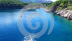 Kayaking / canoeing at Siderona bay, Greece, on a lovely bright day in a calm blue and turquoise sea.