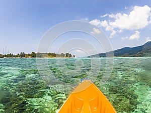 kayaking in crystal clear tropical waters - kayak heading to isolated beach in Ko Tarutao national park