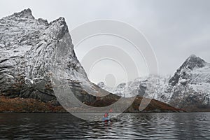 Kayaking into a snowy Reinefjorden