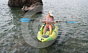 Woman kayak sea. Happy tourist enjoy taking picture outdoors for memories. Woman traveler posing in kayak canoe at sea