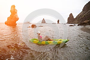 Woman kayak sea. Happy tourist enjoy taking picture outdoors for memories. Woman traveler posing in kayak canoe at sea