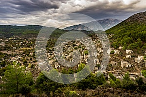 Kayakoy houses panoramic view in historcial Lycian village, Fethiye, Mugla, Turkey. Ghost Town KayakÃ¶y, anciently known as
