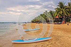 Kayaks on Ba Keo Beach in the evening sun, next to a resort on Phu Quoc, Vietnam