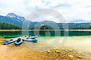 Kayaks docked on the shore of Black Lake. Mountain landscape, Durmitor National Park, Zabljak, Montenegro.