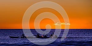 Kayaks racing at dawn