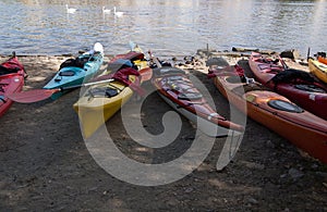 Kayaks on the river bank