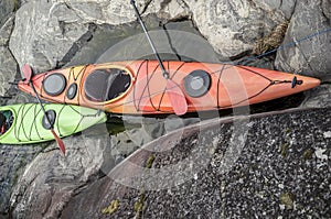 Kayaks stand moored on a rocky seashore. Top view.