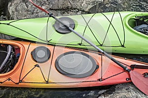 Kayaks stand moored on a rocky seashore. Top view.