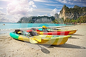 Kayaks on tropical beach, active holidays concept