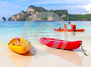 Kayaks on a tropical beach, shallow depth of field.