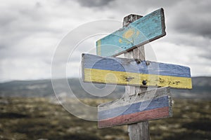 kazahkstan, ukraine and russian flags on signpost