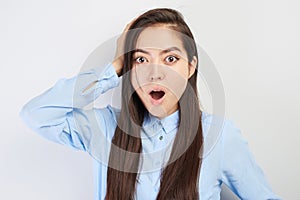 Kazakh Asian shocked girl student in glasses with mouth open surprised has an idea on white studio background