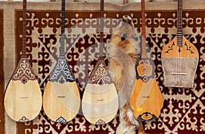 Kazakh national handmade musical instruments with horsehair strings hang on the felt wall