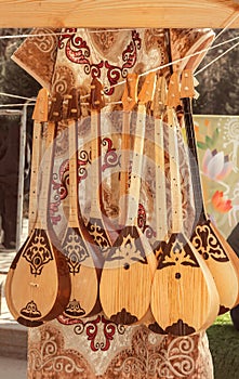 Kazakh national handmade musical instruments with horsehair strings are sold in a street shop