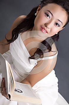 Kazakh young woman with a book in her hands
