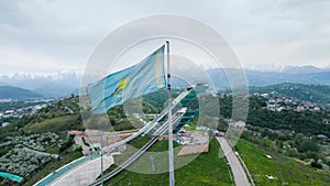 Kazakhstan flag against ski jumping trampoline complex