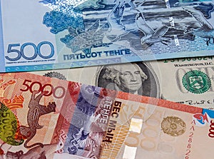 Kazakhstani tenge and US dollar banknotes