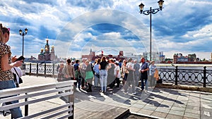 Kazan, Russia - April 29, 2023: Tourists on the waterfront of a city near a river or lake on a summer, autumn, or spring