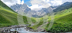 Kazbegi region, Georgia, picturesque mountain landscape wiht Chauhi River and Caucasus mountain range, Juta valley