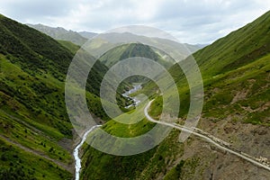 Kazbegi region, Georgia, picturesque mountain landscape wiht Chauhi River and Caucasus mountain range, Juta valley