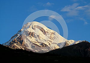 Kazbek mountain covered with snow in Caucasian mountains in Georgia