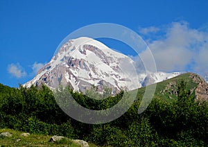 Kazbek mountain covered with snow in Caucasian mountains in Georgia